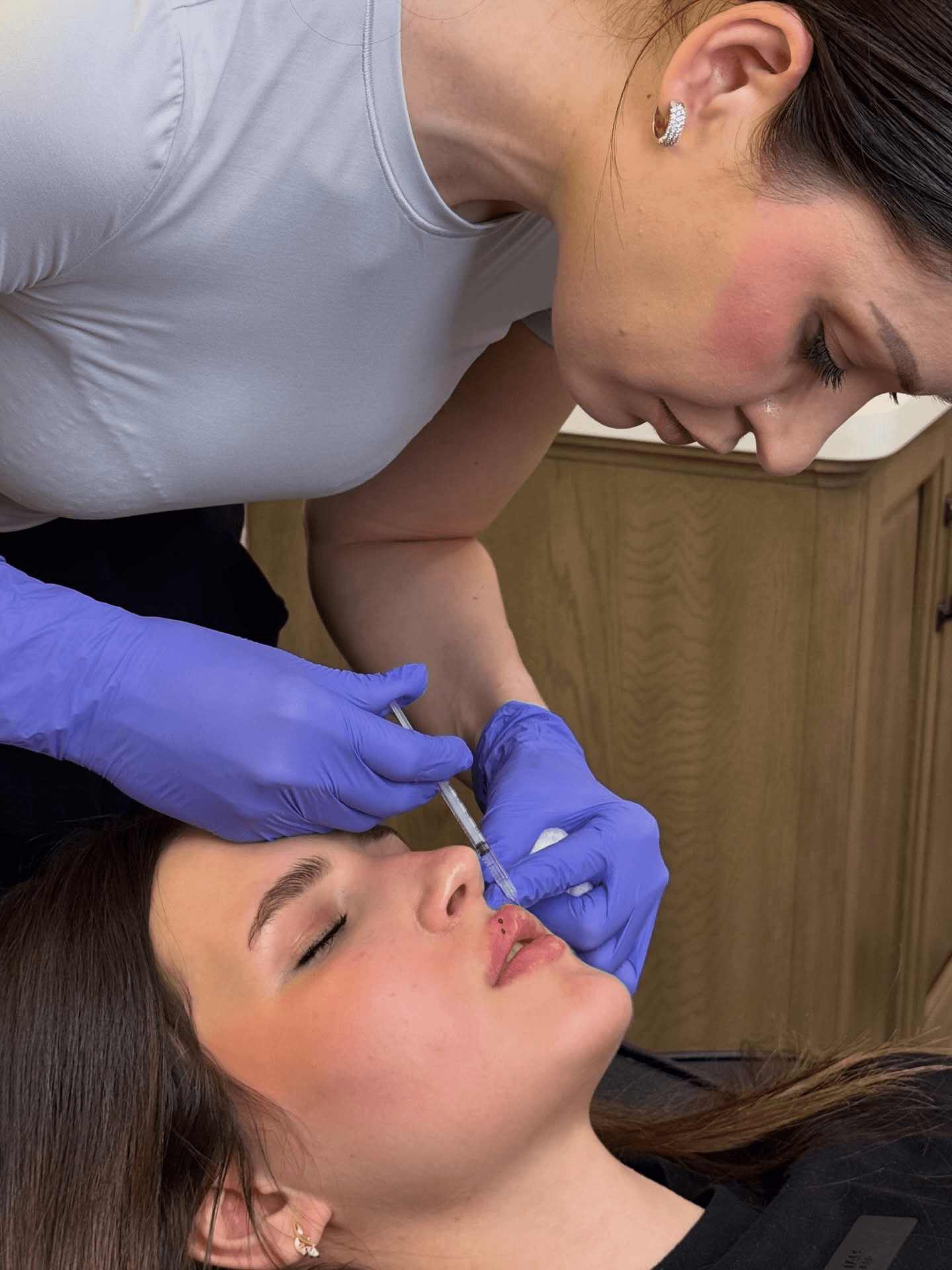 Helen Petrov performing a lip filler treatment at Flawless Aesthetics